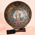 Load image into Gallery viewer, Chenrezig Carved Singing Bowl tuned to B2 and F4 with inner deity artwork, aged brass finish and wooden mallet.