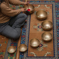 Load image into Gallery viewer, Himalayas Singing Bowl Chakra Set with seven brass bowls arranged by size on a meditation rug