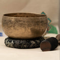 Load image into Gallery viewer, Kopre Singing Bowl for Heart and Third Eye Chakra with aged brass finish, black cushion and wooden mallet