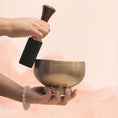Load image into Gallery viewer, Naga Singing Bowl for Throat Chakra with antique brass finish, held in hand with wooden mallet