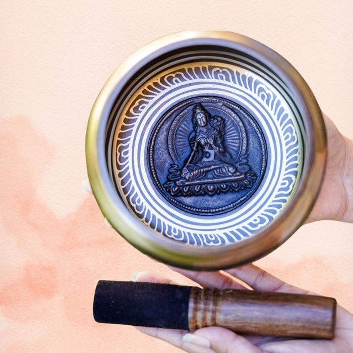 White Tara Singing Bowl with White Tara interior design, polished brass finish and wooden mallet.