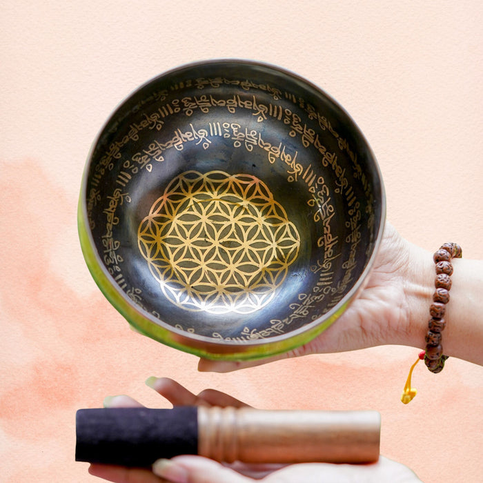 Flower of Life Singing Bowl with symbolic geometry design, mantra-style border, dark aged brass interior and wooden mallet.