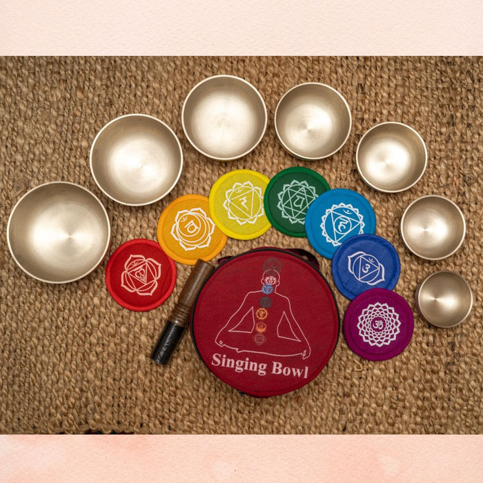 Harmonics Chakra Set Singing Bowl with seven brass bowls, colourful chakra cushions and red carry case.